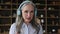 Portrait elderly lady teacher in headphones interact with pupils online