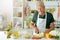 Portrait of elderly making salad at kitchen