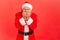 Portrait of elderly man with gray beard wearing santa claus costume biting nails, being nervous terrified, feeling frightened,