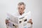 Portrait elderly man reading newspaper