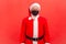 Portrait of elderly santa claus in eyeglasses with protective face mask seriously looking at camera, coronavirus and winter
