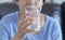 Portrait Elderly woman drinking glass of water to retirement i