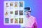 Portrait of elderly woman in VR glasses choice food at internet shop, point at digital screen. Purple gradient