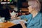Portrait of an elderly woman working in front of laptop monitor sitting Lifestyle unaltered