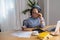 Portrait of an elderly woman working inside the house using laptops and tablets to work and check important documents for