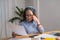 Portrait of an elderly woman working inside the house using laptops and tablets to work and check important documents for