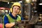 Portrait of an electrician at work in the industry. Professional technicians are checking the system of the machine with a laptop