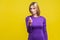 Portrait of elegant businesswoman showing money gesture. indoor studio shot isolated on yellow background