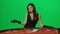 Portrait of elegant female on chroma key green screen. Attractive woman player standing at the blackjack poker table