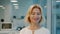 Portrait of elegant mature businesswoman smiling in office looking at camera