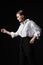 Portrait of an elegant young woman in a white shirt and black pants. Interesting studio light