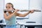 Portrait of elementary girl playing flute in classroom