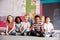 Portrait Of Elementary School Pupils Sitting On Floor In Classroom