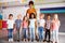 Portrait Of Elementary School Pupils Standing In Classroom With Female Teacher