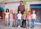 Portrait Of Elementary School Pupils Standing In Classroom With Male Teacher