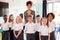 Portrait Of Elementary School Pupils Wearing Uniform Standing In Classroom With Female Teacher