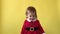 Portrait Emotion Cute Smiling Happy Cheerful Toddler Baby Girl In Santa Suit Looking On Camera At Yellow Background