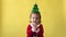 Portrait Emotion Happy Chubby Toddler Baby Girl In Santa Suit. Child Smiling Cute Closes Eyes With Hands Christmas Tree