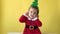 Portrait Emotion Happy Chubby Toddler Baby Girl Santa Suit With Christmas Tree on Head Looking On Camera At Yellow