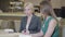 Portrait of emotional Caucasian blond woman talking and gesturing as sitting in cafe with brunette friend or colleague