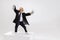 Portrait of emotional little boy, child businessman in huge jacket suit standing on big box isolated on white studio