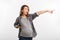 portrait of emotional pregnant woman pointing away