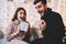 Portrait of emotional young woman and man excited with christmas presents from each other