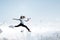 Portrait of energetic businesswoman with megaphone jumping in open air