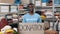 Portrait of energetic multiracial man looking at the camera and smiling while holding banner with donation word in