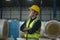 Portrait of engineer man  putting a protective helmet on  head in warehouse