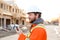 Portrait of engineer talking by walkie talkie on construction site.