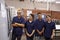 Portrait Of Engineer Training Apprentices On CNC Machine