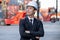 Portrait of engineer worker of factory technician with Chinese style stand in front of cargo container crane in workplace area.