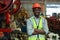 Portrait engineering black male African American workers wear red helmet arm crossed pose standing at machine area in factory,
