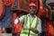 portrait engineering black male African American workers wear red helmet arm crossed pose standing at machine area in factory,