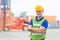 portrait of engineering man wearing uniform safety suit and helmet in industrial containers for shipping.