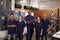 Portrait Of Engineers And Apprentices With CNC Machine