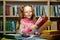 portrait of enthusiastic schoolgirl with stack of books