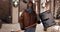 Portrait of enthusiastic woman with a snow shovel outdoors