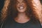 Portrait of ethnic redhead curly-haired woman with freckles.