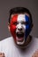 Portrait Euphoric scream of France football fan in win game of France national team on grey background.