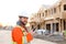 Portrait of european engineer talking by walkie talkie on construction site.