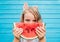 Portrait of excited adorable child holding red ripe watermelon w