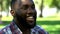 Portrait of excited afro-american man smiling, enjoying life, spending weekend