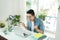 Portrait of excited asian young man working on laptop computer a