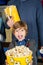 Portrait Of Excited Boy Showing Popcorn At Cinema