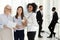 Portrait excited diverse female colleagues looking at camera in office