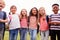 Portrait Of Excited Elementary School Pupils On Playing Field At Break Time