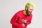 Portrait of excited happy yellow-haired man with beard, dresses in casual red sweater, laughing loud, hearing really funny thing,