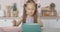 Portrait of excited little girl opening gift box with surprised facial expression. Pretty brunette Caucasian kid